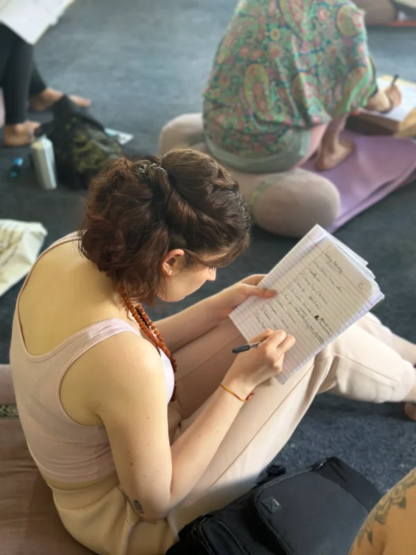 yoga-students-making-notes-in-yoga-class-at-pyramid-yogshala-.webp